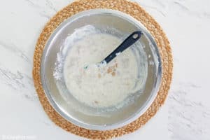 stirring clams into to dip mixture.