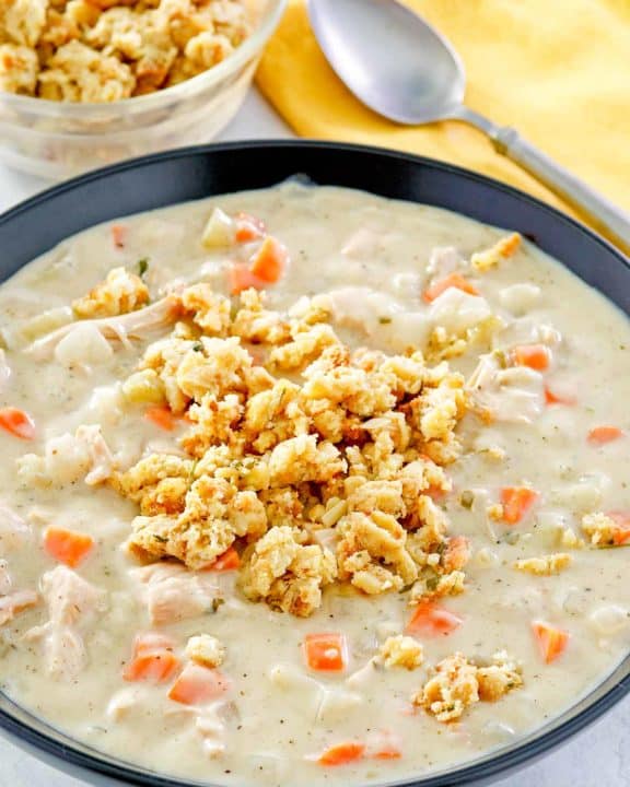 creamy turkey soup topped with stuffing in a bowl.