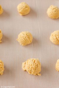 ginger snap cookie dough balls on a baking sheet.