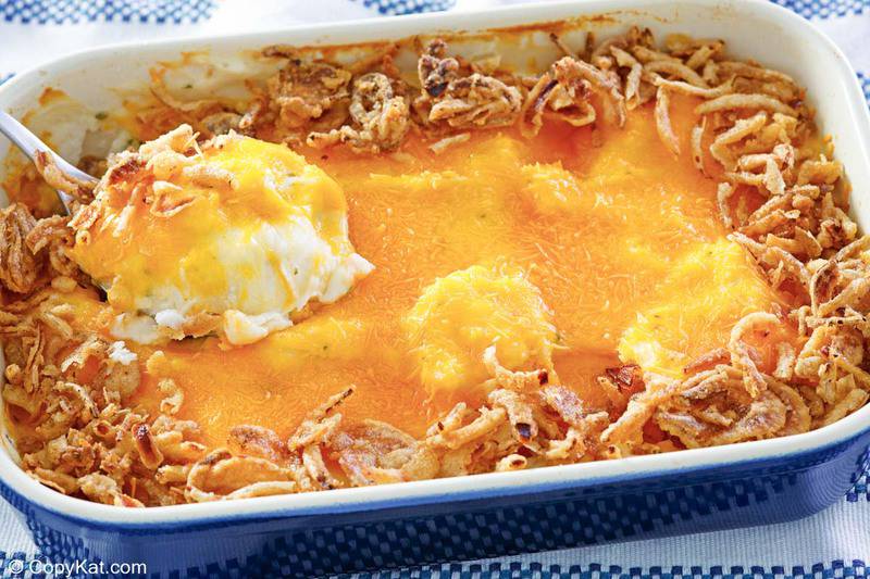 mashed potato casserole with a scoop of it on a serving spoon.