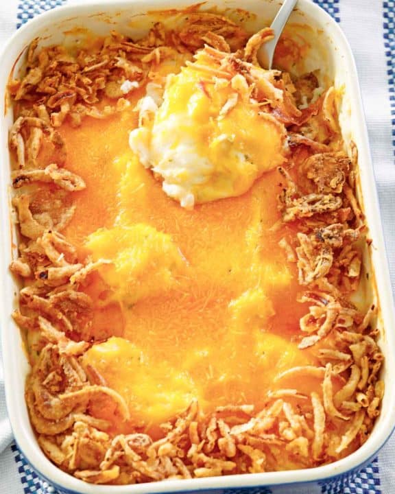 mashed potato casserole with cheese and crispy fried onions on top.