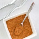 overhead view of homemade old bay seasoning in a small square bowl.