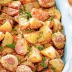 roasted parmesan potatoes in a serving dish.