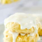 three iced pineapple cookies in a stack.