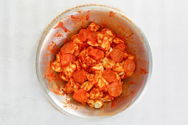 pizza monkey bread mixture in a bowl.