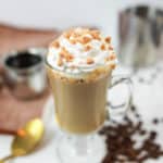 homemade Starbucks butterscotch latte topped with whipped cream and crushed candy.