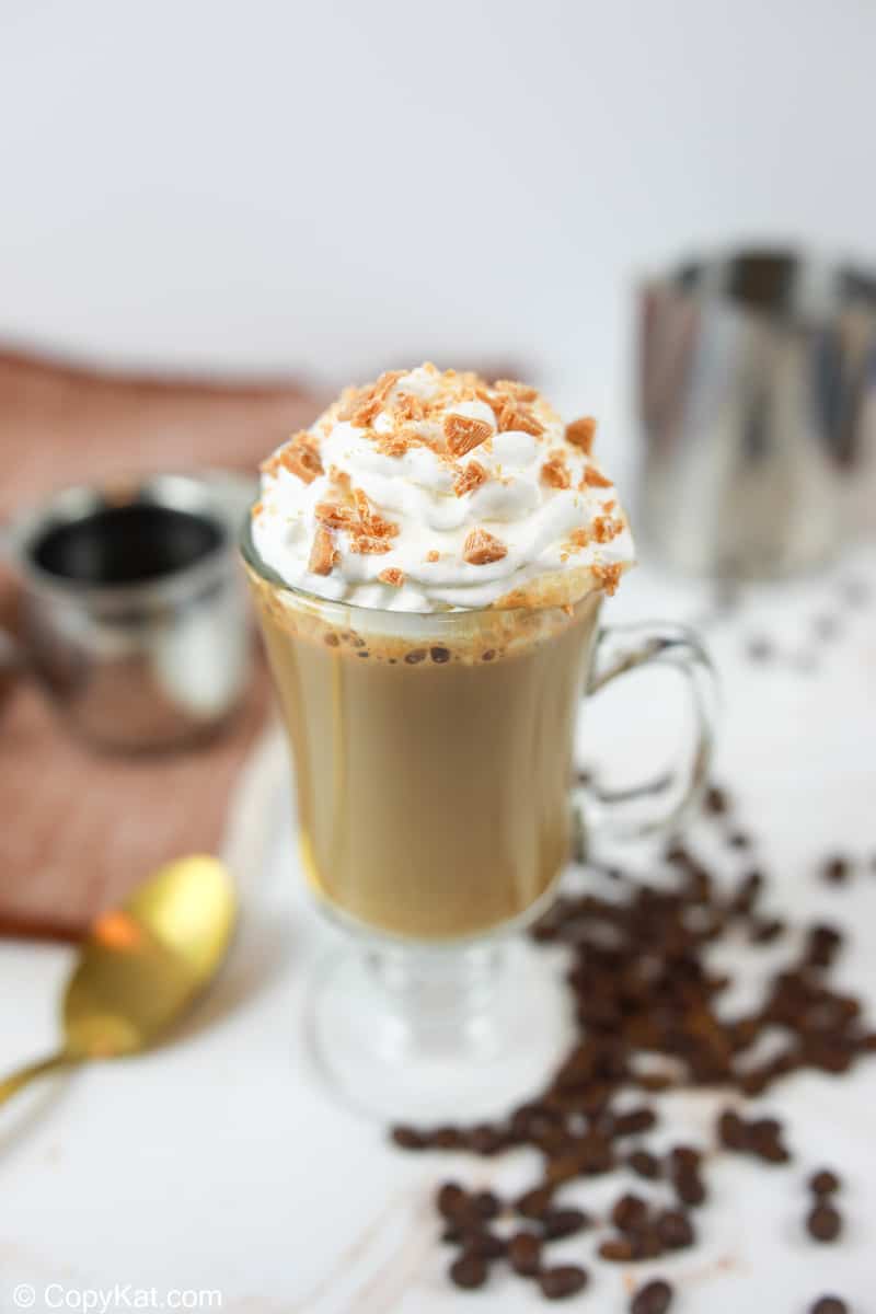 homemade Starbucks butterscotch latte topped with whipped cream and crushed candy.