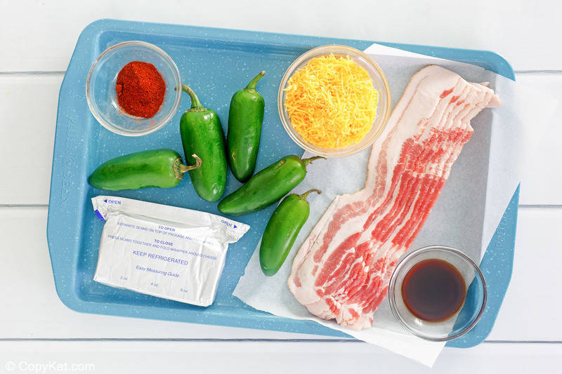 bacon wrapped jalapeno poppers ingredients on a tray.