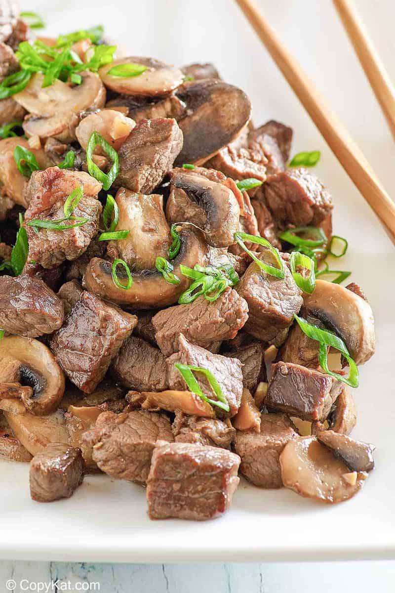 hibachi steak and mushrooms on a platter.