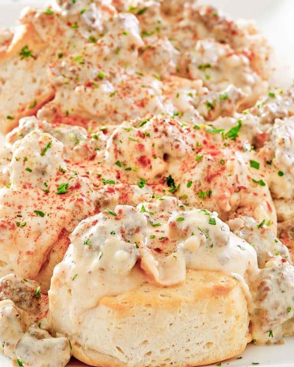 homemade Bob Evans Sausage gravy over biscuits on a platter.