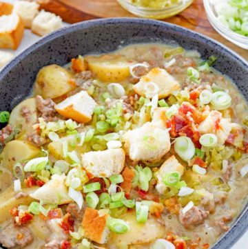 cheeseburger soup with hamburger bun croutons on top.