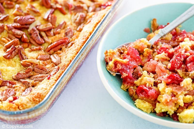 cherry pineapple dump cake in a baking dish and on a plate.