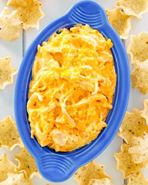 overhead view of Frank's Buffalo chicken dip in a dish and tortilla chips around it.