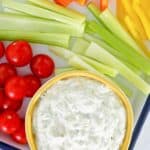 overhead view of green goddess dip and vegetables on a tray.