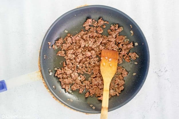 browned ground beef and onions in a skillet.