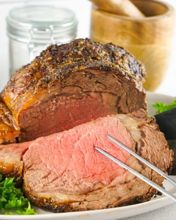 slicing a prime rib ribeye roast.