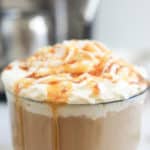 homemade Starbucks caramel latte in a glass mug.