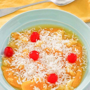 bowl of ambrosia fruit salad and a spoon.