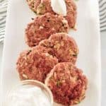 chicken croquettes, sour cream, and fresh dill on a platter.