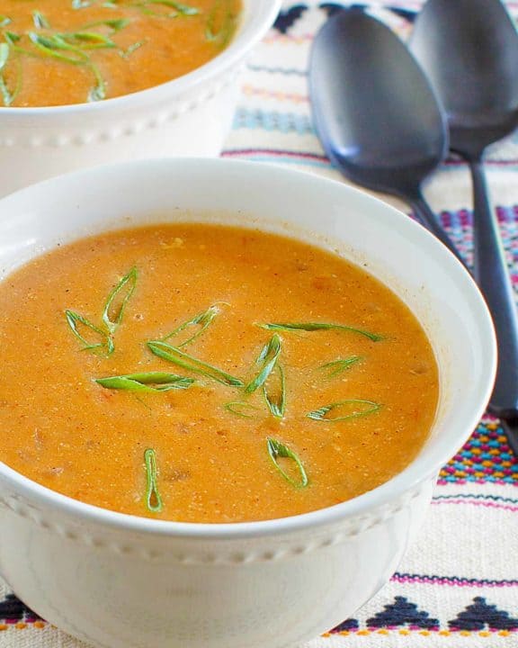 copycat Chili's chicken enchilada soup garnished with green onions.