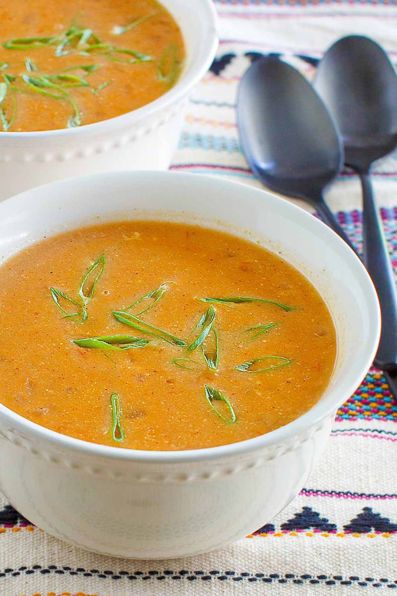 copycat Chili's chicken enchilada soup garnished with green onions.