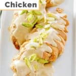 two cream cheese chicken breasts on a platter.