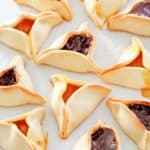 Hamentashen on parchment paper.