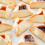 Hamentashen cookies on parchment paper.