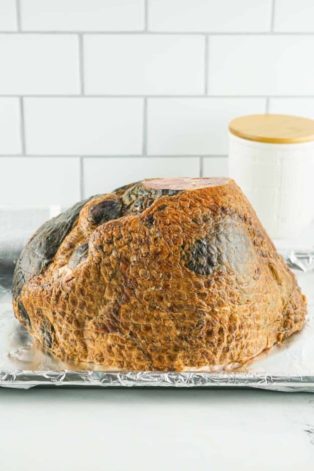 ham with open meat side down on a foil-lined baking sheet.