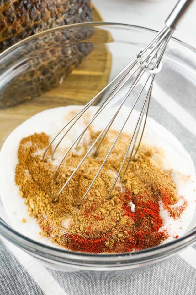 combining honey baked ham glaze mixture with a whisk.