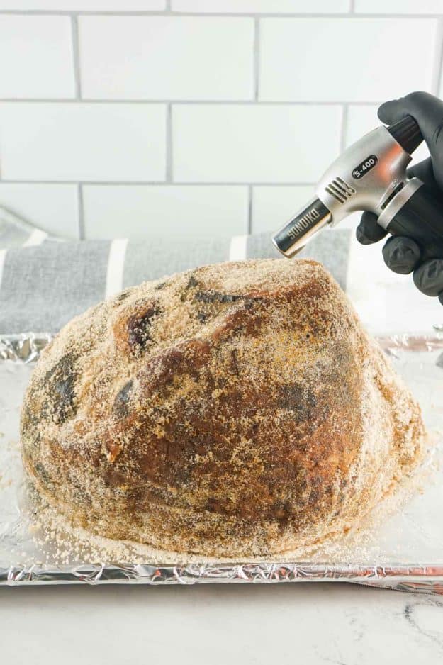 blowtorch and glaze coated honey baked ham.