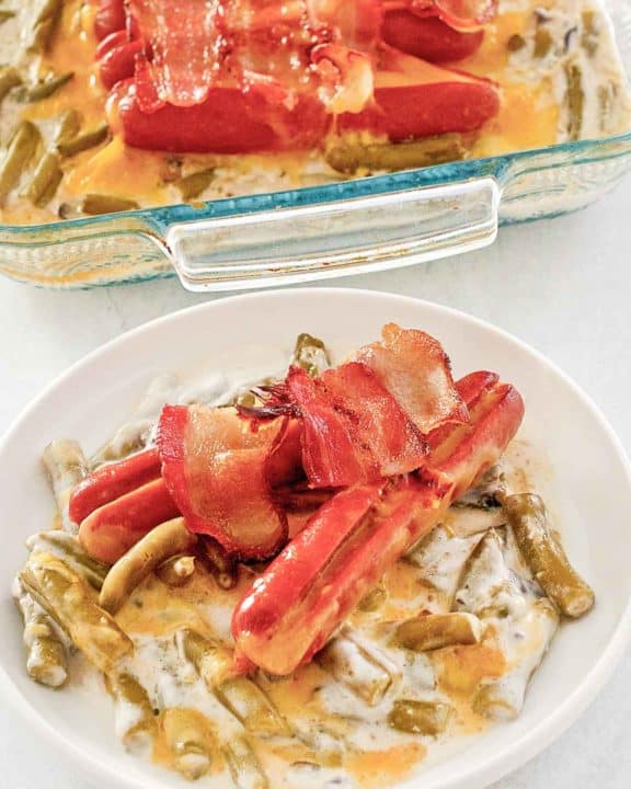 green bean hot dog casserole on a plate and in a baking dish.