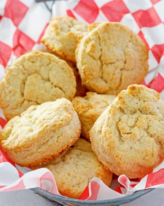 copycat KFC buttermilk biscuits in a parchment-lined basket.