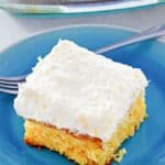 mandarin orange cake slice and a fork on a plate.