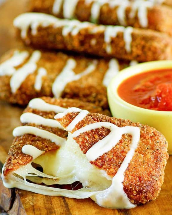 copycat Olive Garden Fried Mozzarella Sticks on a wood board.