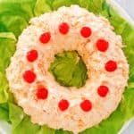 overhead view of orange fluff jello salad on a platter.