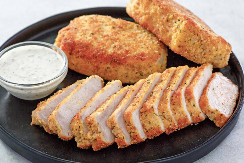 pork milanese with lemon caper sauce on a platter.