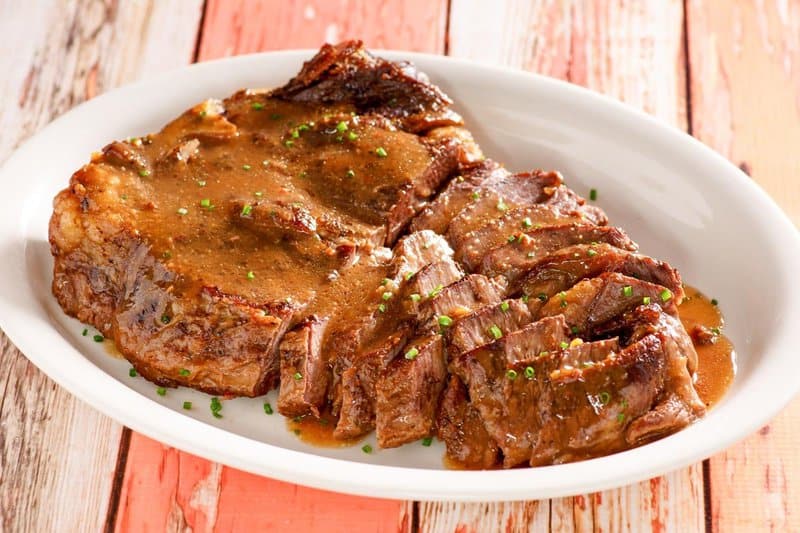 to die for roast beef and gravy on a platter.