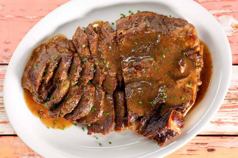 overhead view of to die for roast beef and gravy on a platter.