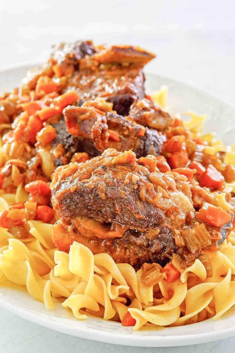 braised short ribs with noodles on a platter.