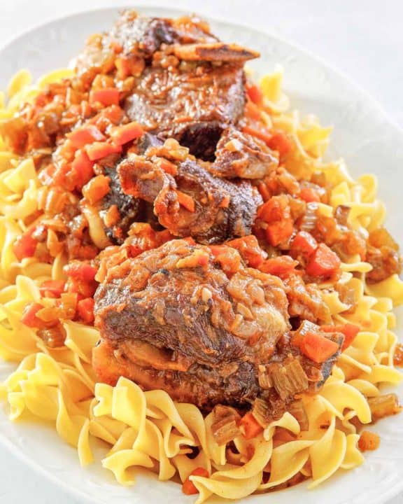 braised short ribs and noodles on a platter.