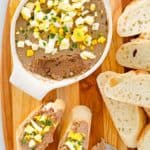 overhead view of chicken liver pate in a dish and on bread slices.
