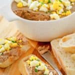 chicken liver pate in a dish and on bread slices.