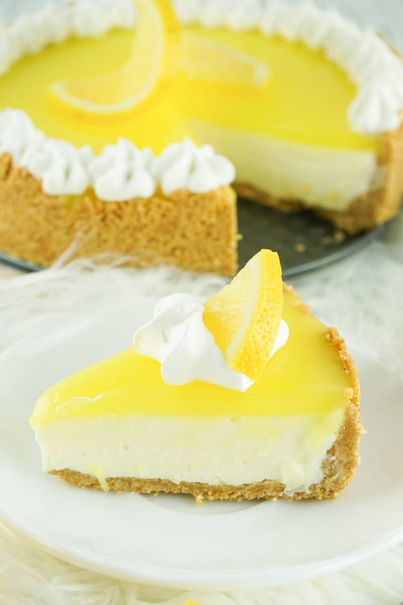 lemon cream cheese pie slice on a plate in front of the pie.