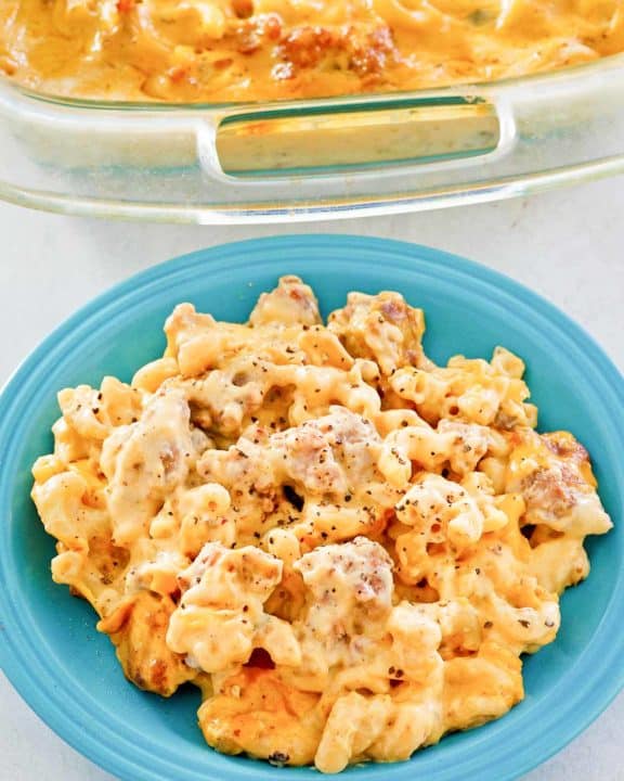sausage mac and cheese casserole on a plate and in a baking dish.