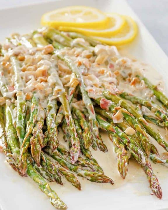 sauteed asparagus with lemon cream sauce on a platter.