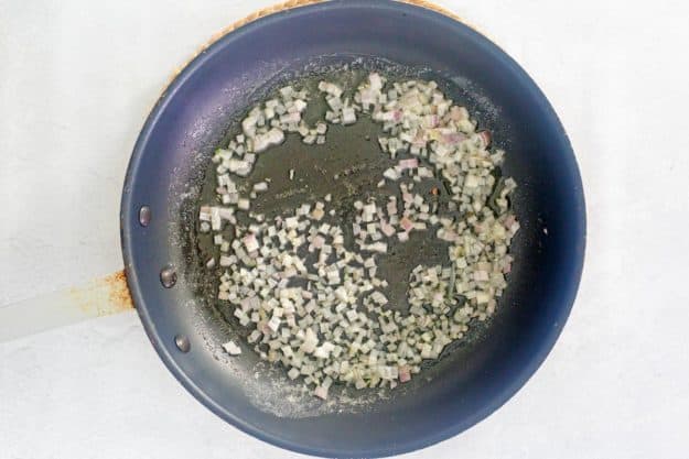 butter sauteed shallots in a skillet.