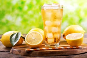 a glass of sweet iced tea and lemons.