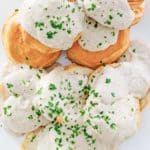 overhead view of white gravy over biscuits.
