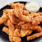 beer battered chicken and sauce on a platter.